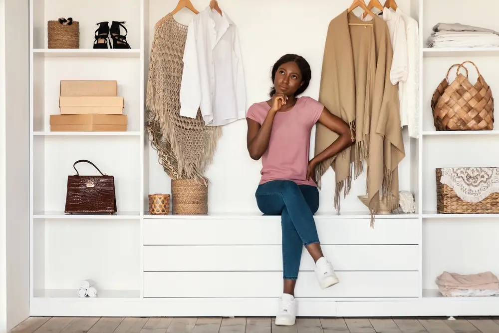 A black lady preparing her wardrope for a two week vaction