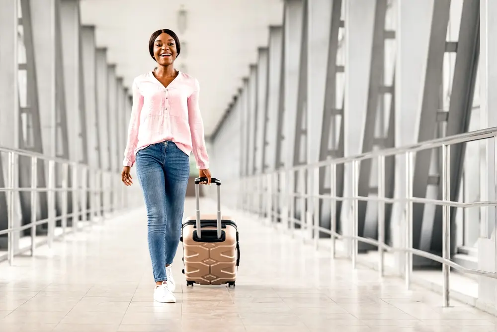 A blscking lady travelling with her lugguage 