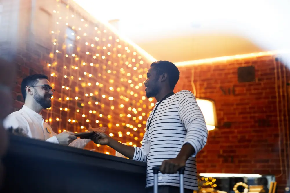 A black man checking in on a hotel