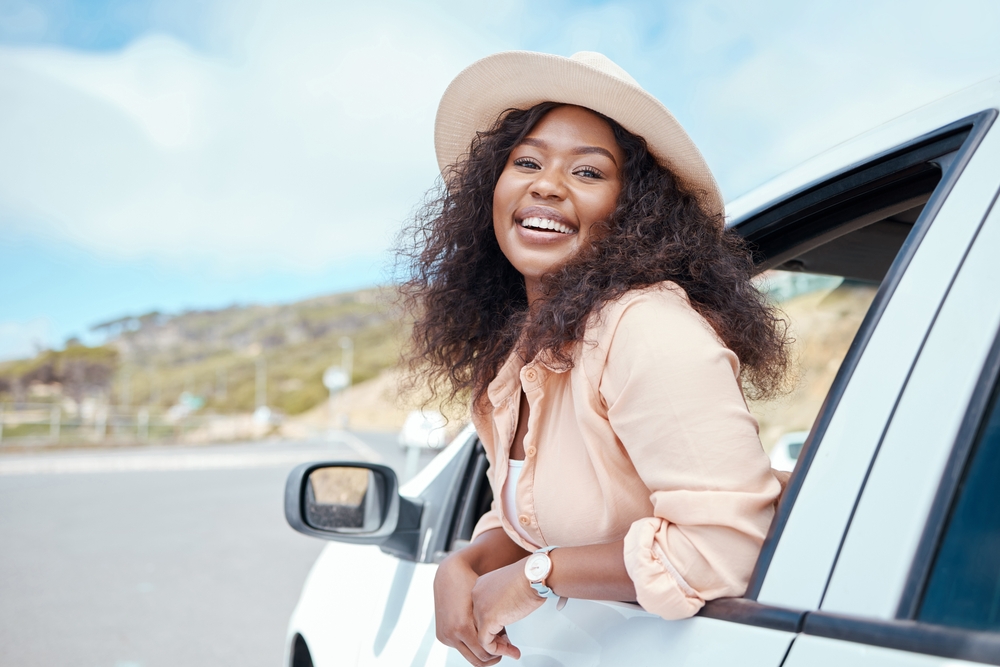 A black woman visiting west African countries. Road trip travel black woman and car window freedom to relax in summer vacation and outdoor adventure in South Africa countryside.