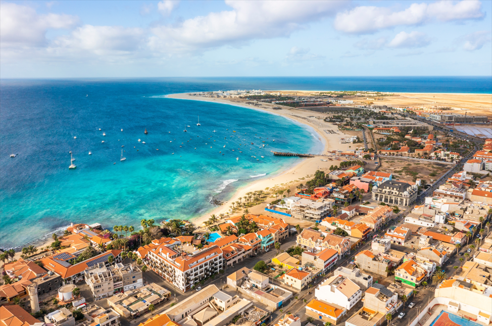 Pier and boats on turquoise water in city of Santa Maria, Sal, Cape Verde