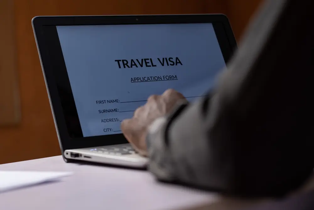 A man filling out a Visa form for Visa free countries