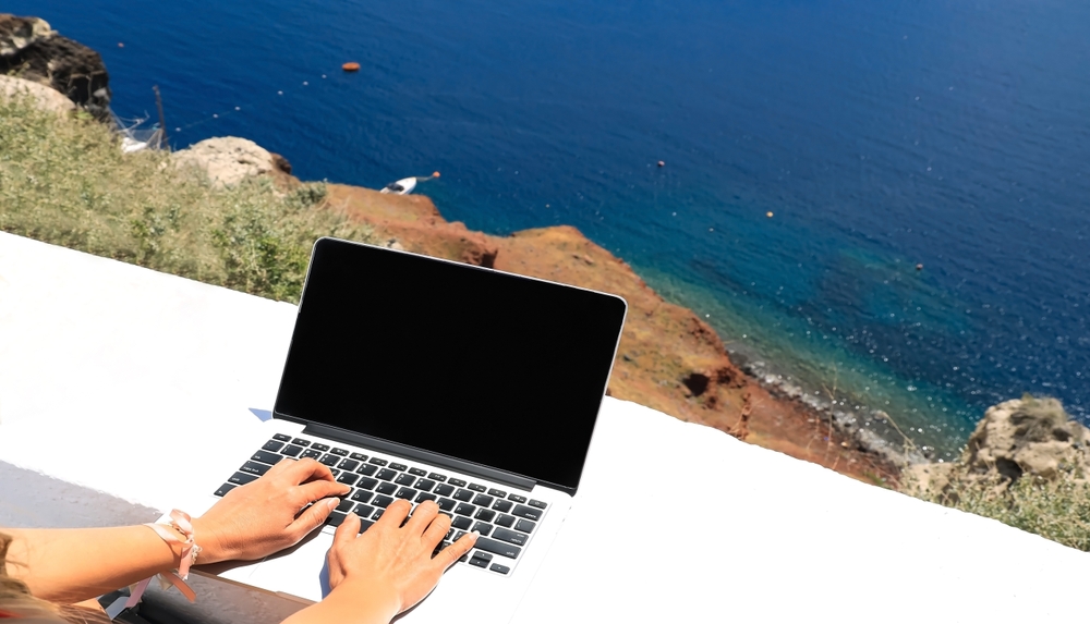 Digital nomad visa freelancer woman as running remotely with bright scenic view of the sea 