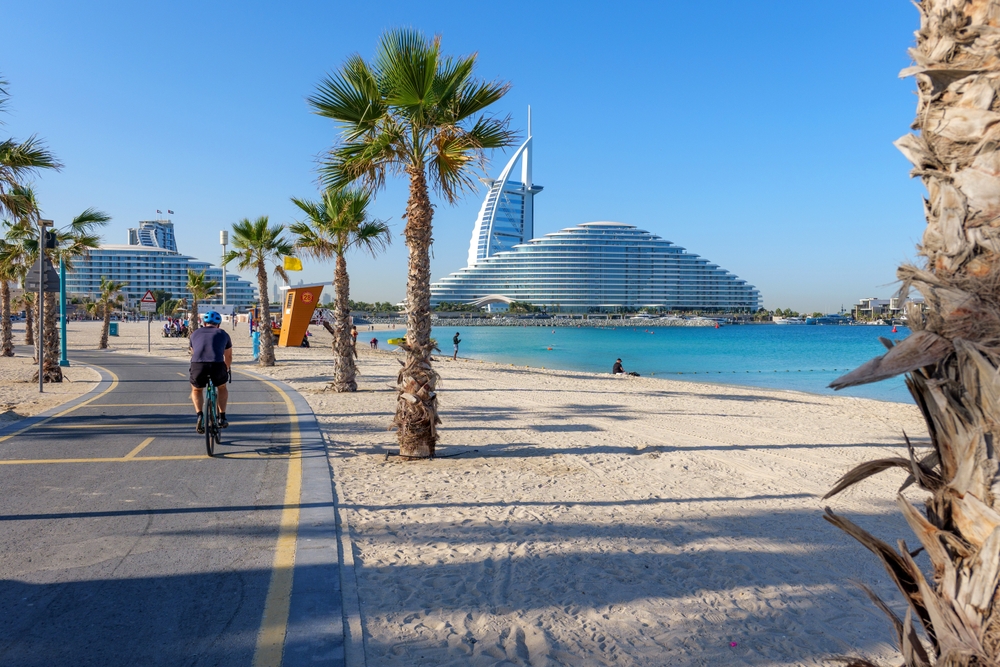 Scenic view of Burj Al Arab from a palm-lined bike path along Kite Beach in Dubai, UAE. A modern cityscape combining iconic architecture, luxury, and coastal charm. 24 january 2025, Dubai, UAE
